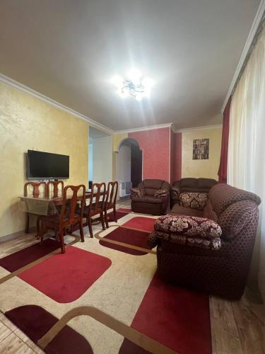 a living room with a couch and a table at Appartment in the city center in Gyumri