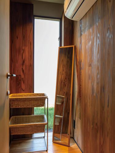 a room with a mirror and a wooden wall at YANMAR SUNSET MARINA CLUBHOUSE&HOTEL in Moriyama