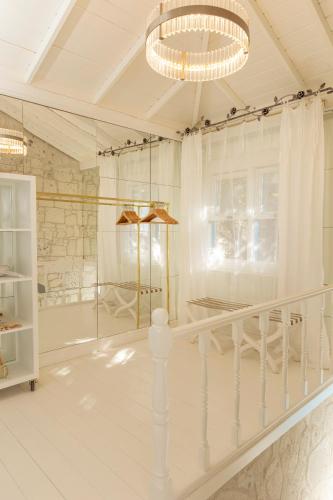 a white room with a staircase and a chandelier at Sabrinas Haus - Adult Only +14 in Bozburun