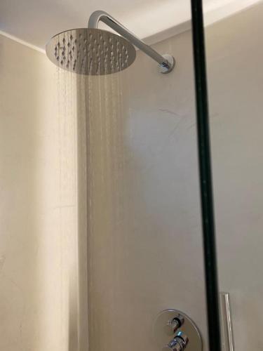 a shower with a shower head in a bathroom at Kikkos Village House in Néa Koróni