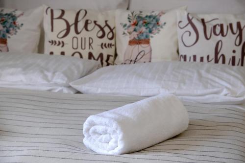 a white towel on a bed with two beds at Bakonyi Porta Olaszfalu in Olaszfalu
