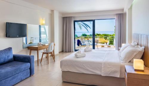 a hotel room with a bed and a view of the ocean at Ionian Theoxenia in Kanali
