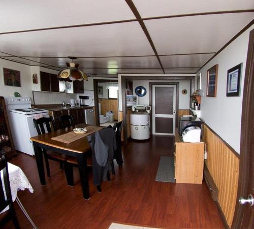a kitchen and dining room with a table in a rv at Bird Island B&B in Elliston