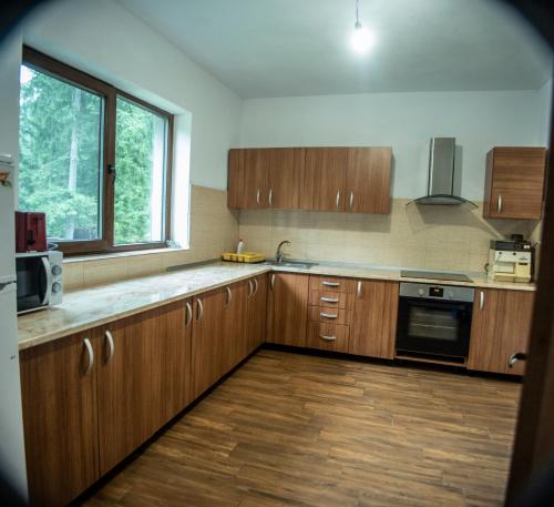 una cucina con armadi in legno e una finestra di Cabana Stan ad Arieşeni