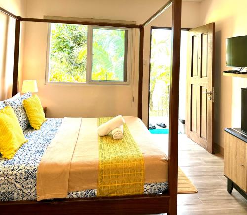 a bedroom with a large bed with a window at Vivo Siargao in General Luna