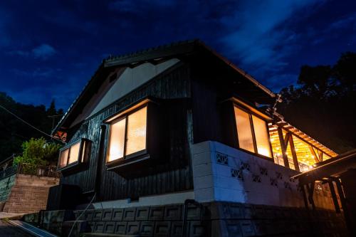 a house lit up at night at Naoshima Juju Art House　直島ジュジュアートハウス in Naoshima