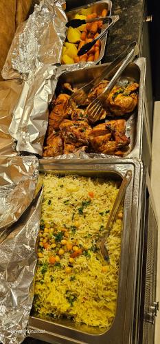 a group of trays of food on a counter at Al Namteh Lodge in ‘Ābil