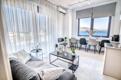 een woonkamer met een bank en een tafel bij Maison Poème - Luxury Apartments in Aiándion