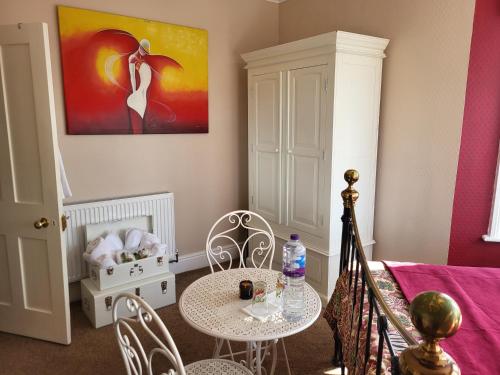 a room with a table and chairs and a bed at Ocean Retreat Norfolk in Trimingham