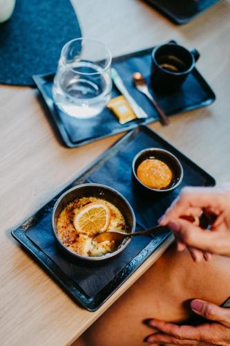 a person sitting at a table with a plate of food at ALMHOF Alpin Apartments & Spa in Dienten am Hochkönig