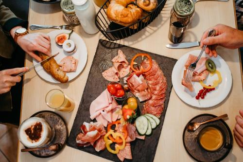 a table with a bunch of food on it at ALMHOF Alpin Apartments & Spa in Dienten am Hochkönig