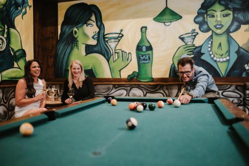 a group of people sitting around a pool table at ALMHOF Alpin Apartments & Spa in Dienten am Hochkönig
