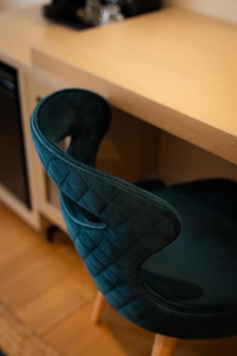 a black chair sitting under a desk with a desk at Navria by Aetoma in Nafplio