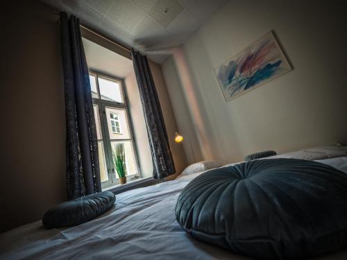 a bedroom with a large pillow on a bed with a window at Hostel Pod Basztą in Lublin