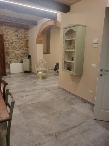 a living room with a stone floor and an open door at Villa Torricelli Scarperia - Il Giardinetto Residence in Scarperia