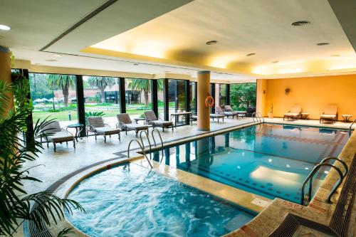 a large swimming pool with chairs and tables in a building at Sheraton Pilar Hotel & Convention Center in Pilar