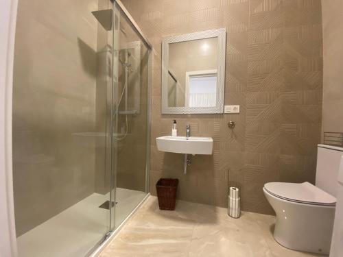 a bathroom with a shower and a sink and a toilet at Apartamento La Mamola in La Mamola