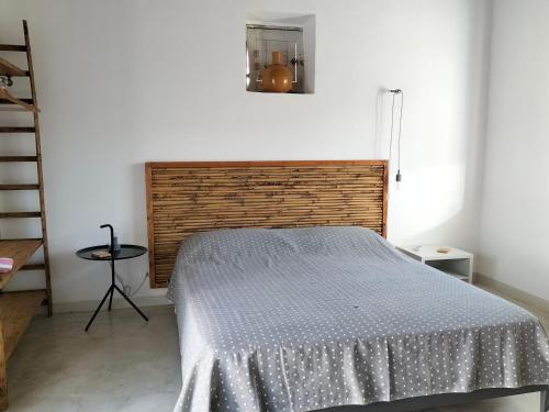 a bedroom with a bed with a wooden headboard at Casa Giufà B&B in Chiaramonte Gulfi