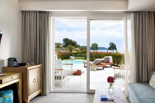 a living room with a sliding glass door to a patio at Alexandra Elegance Bridging Generations in Potos