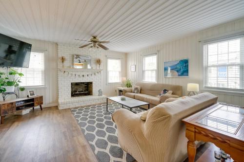 a living room with a couch and a fireplace at Carolina Beach Home with Private Deck Walk to Shore in Carolina Beach