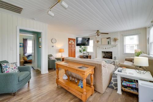 a living room with a couch and a table at Carolina Beach Home with Private Deck Walk to Shore in Carolina Beach