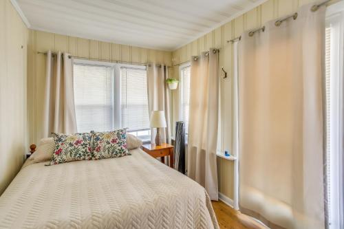 a bedroom with a bed and a window at Carolina Beach Home with Private Deck Walk to Shore in Carolina Beach