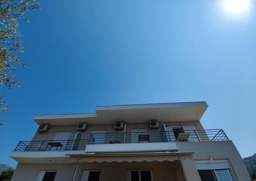 a building with a balcony on top of it at Penelope & Michael Rooms in Himare