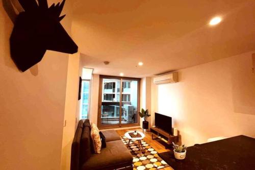 a living room with a horse head on the wall at Nest Apartments on Rose Lane in Melbourne