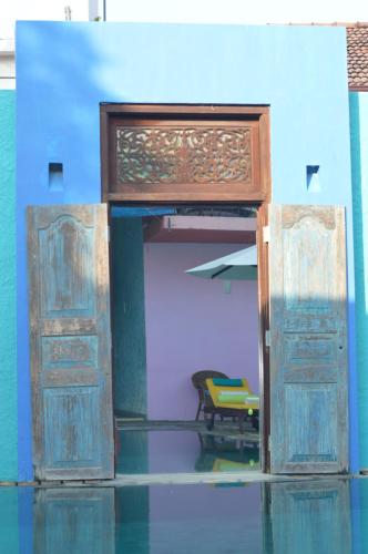 an open door with a chair and a table at Dickman Resort "The Boutique Hotel" in Negombo