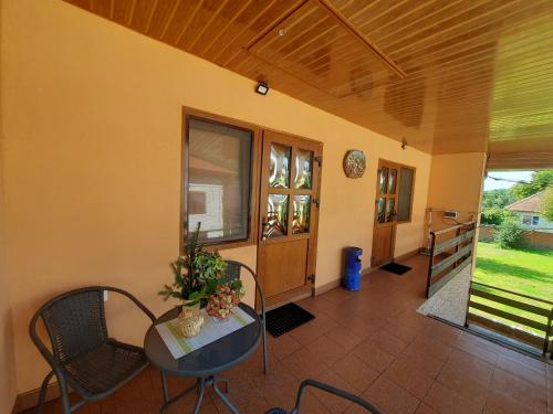 a room with a table and chairs and a hallway at КОМФОРТ in Karpaty