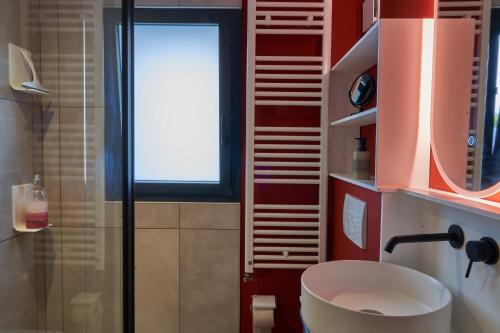 a bathroom with a toilet and a sink and a window at Gîte de Bonneville in Nantes