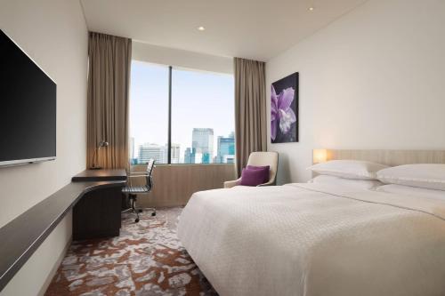 Habitación de hotel con cama grande y ventana grande. en Four Points by Sheraton Jakarta Thamrin en Yakarta
