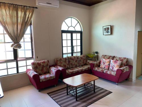 - un salon avec deux canapés et une table dans l'établissement Sri Panorama Home, à Kota Bharu