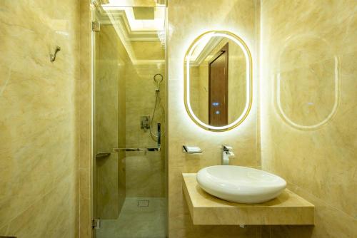 a bathroom with a sink and a shower with a mirror at Ritz Residence, Imago Mall Loft B in Kota Kinabalu