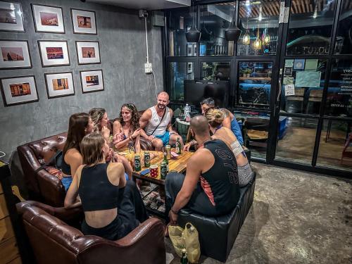a group of people sitting around a table in a room at 84 Gallery in Chiang Mai
