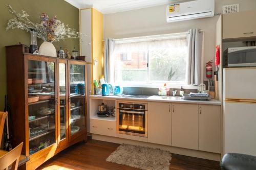 a kitchen with a stove and a window at Kurranulla Sapphire - U3 in Cronulla