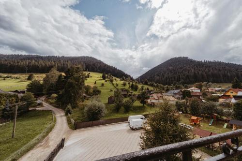 a white van parked in a parking lot in a village at Complex Turistic Constantin Bucovina in Câmpulung Moldovenesc