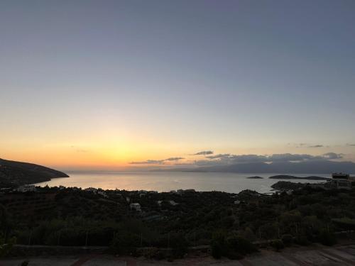 a view of the ocean at sunset at Villa Michelangelo in Agios Nikolaos