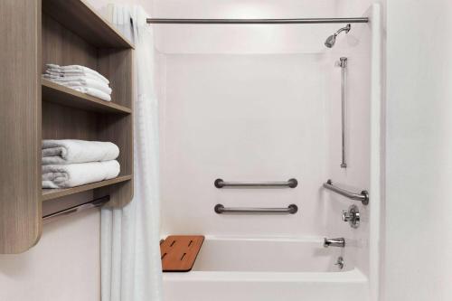 a bathroom with a shower and a bath tub at Microtel Inn & Suites by Wyndham Florence/Cincinnati Airpo in Florence