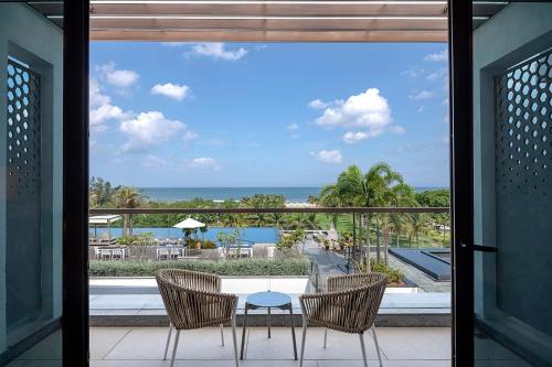 a view of the ocean from the balcony of a resort at Sheraton Grand Chennai Resort & Spa in Mahabalipuram