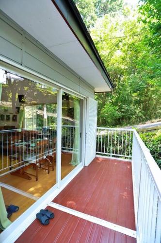 a porch of a house with a wooden deck at FOREST HOUSE NIKKO in Nikko