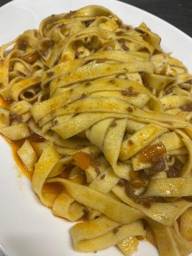 a plate of pasta on a white plate at Albergo Alla Posta in Anduins