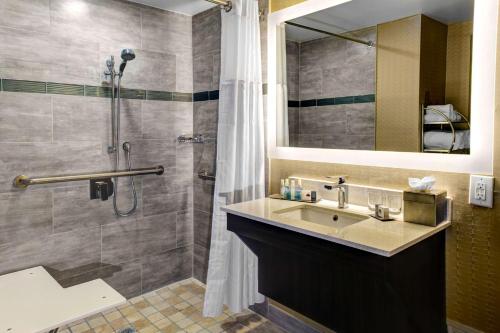 a bathroom with a sink and a shower at Doubletree by Hilton Arlington DFW South in Arlington