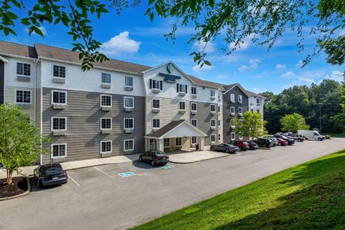 an image of a hotel with a parking lot at WoodSpring Suites Louisville Southeast in Louisville