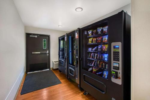 a soda vending machine in a room with drinks at WoodSpring Suites Louisville Southeast in Louisville