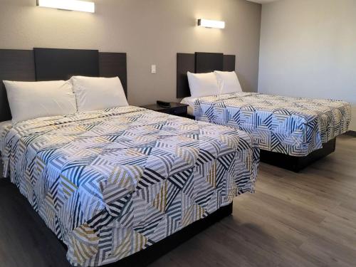 a hotel room with two beds in a room at Motel 6 Wichita KS South I35 in Wichita