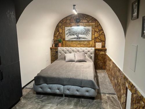 a bedroom with a bed in a stone wall at Аппартаменты in Odesa