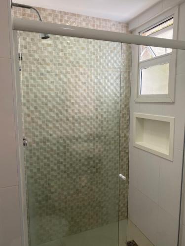 a shower with a glass door in a bathroom at Vista Espetacular Porto Real suítes in Mangaratiba