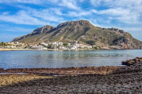 a view of a mountain from the shore of a body of water at Sea View Family Villa with Private Pool, San Juan de los Terreros in Pulpí