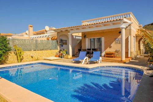 a swimming pool in front of a house at Sea View Family Villa with Private Pool, San Juan de los Terreros in Pulpí